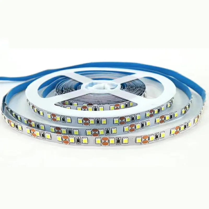 Close-up of a flexible white LED light strip with many small LEDs, bent to show its flexibility.