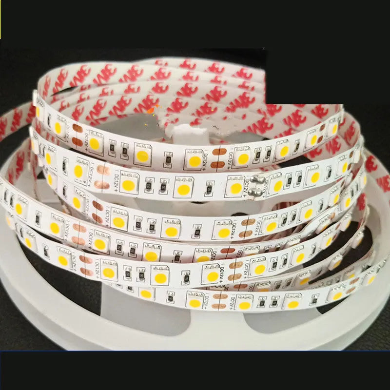 Close-up of a flexible white LED light strip with many small LEDs, bent to show its flexibility.