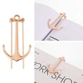Creative metal bookmark page folder in silver colour, 1.78 x 6.6 cm, on an open book