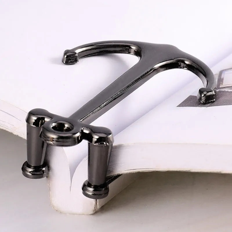 Creative metal bookmark page folder in silver colour, 1.78 x 6.6 cm, on an open book
