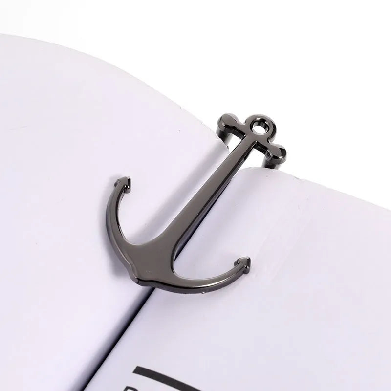 Creative metal bookmark page folder in silver colour, 1.78 x 6.6 cm, on an open book