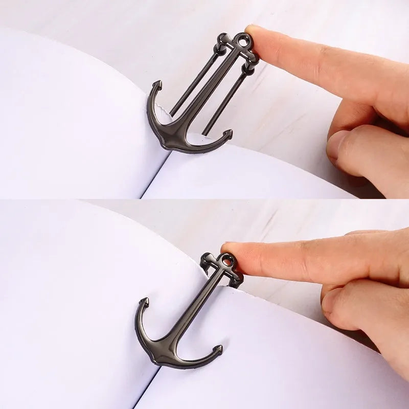 Creative metal bookmark page folder in silver colour, 1.78 x 6.6 cm, on an open book