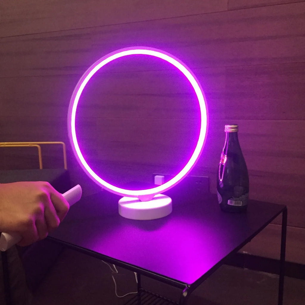 White Full Moon Lamp table light with remote control on a wooden surface.