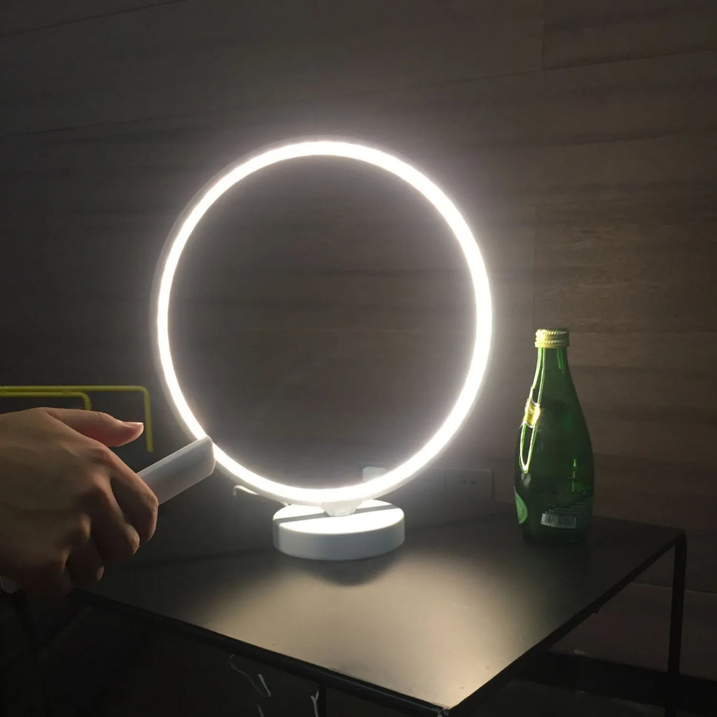 White Full Moon Lamp table light with remote control on a wooden surface.