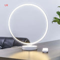 White Full Moon Lamp table light with remote control on a wooden surface.