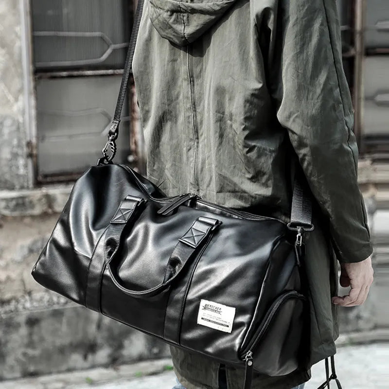 Black waterproof PU leather sports training bag showing internal laptop and camera pockets