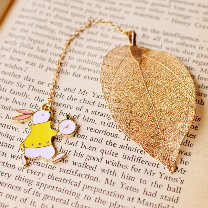 Kraft paper bookmark with kc alloy Alice, rabbit, clock, and leaf charms on cardboard backing