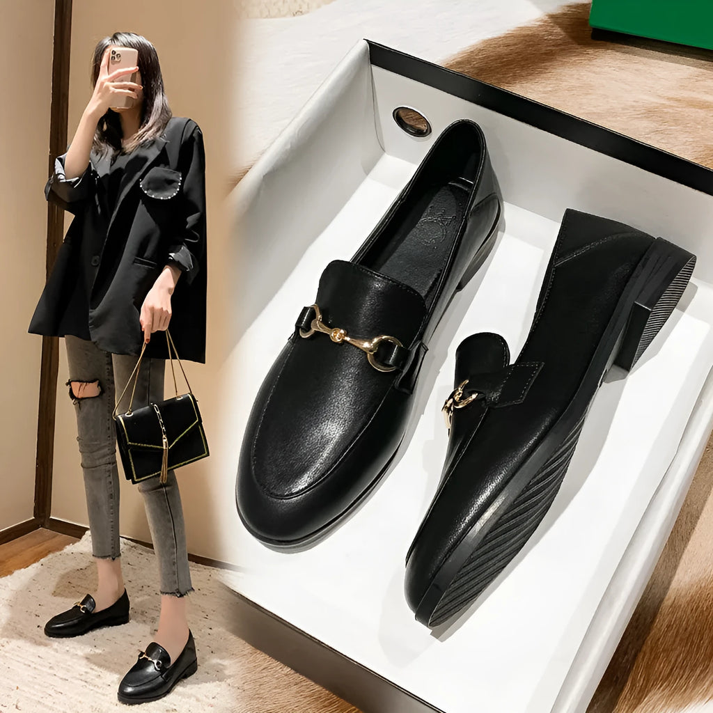 Women's black leather flat shoes with round toe, low heel 1-3cm, and rubber sole on white background