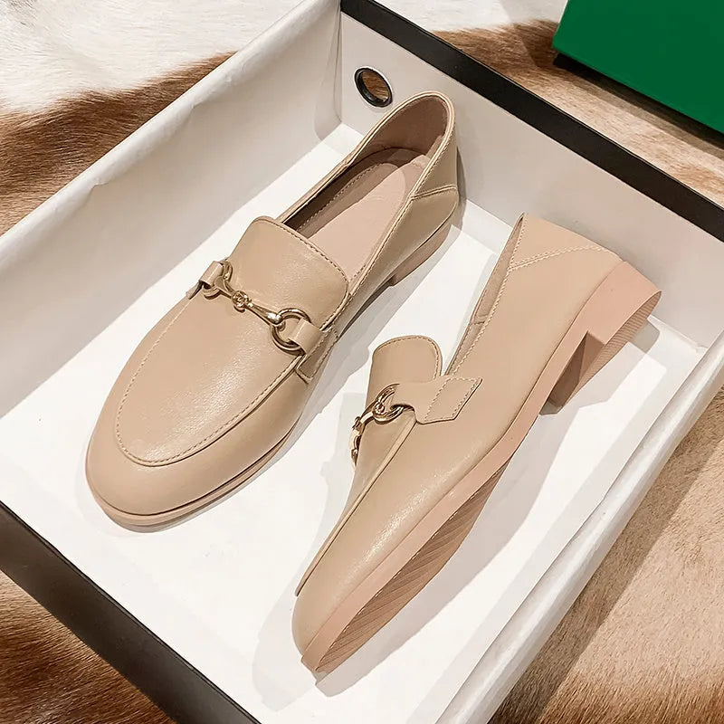 Women's black leather flat shoes with round toe, low heel 1-3cm, and rubber sole on white background