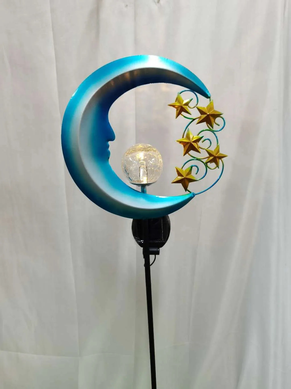 Solar hollow wrought iron blue moon LED lawn light with crack glass ball on grass