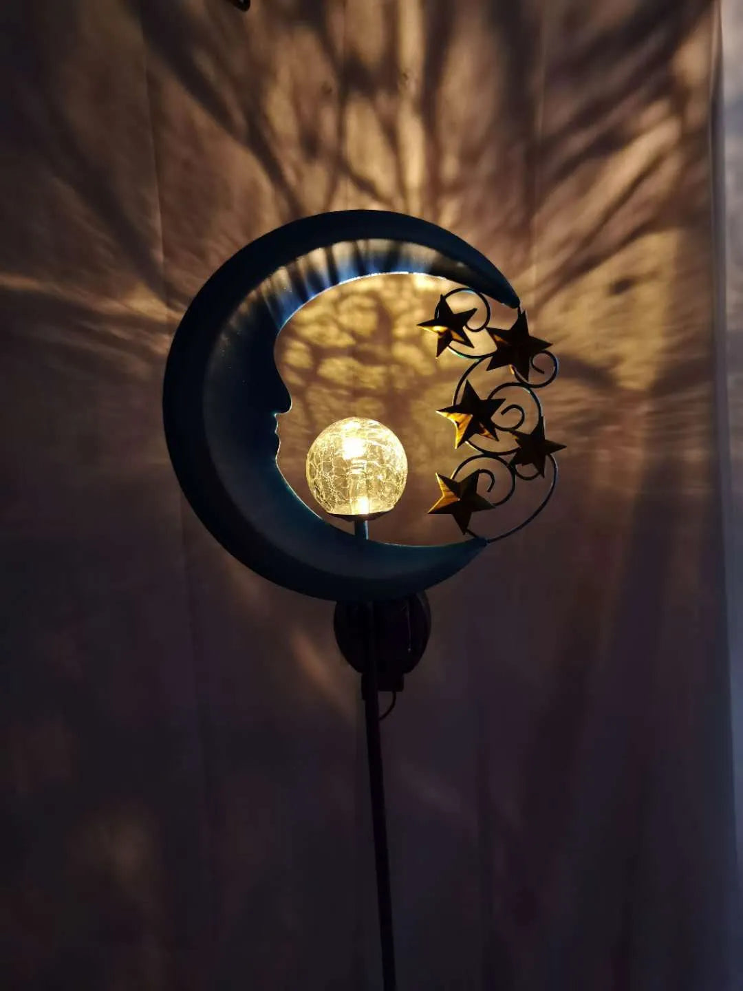 Solar hollow wrought iron blue moon LED lawn light with crack glass ball on grass