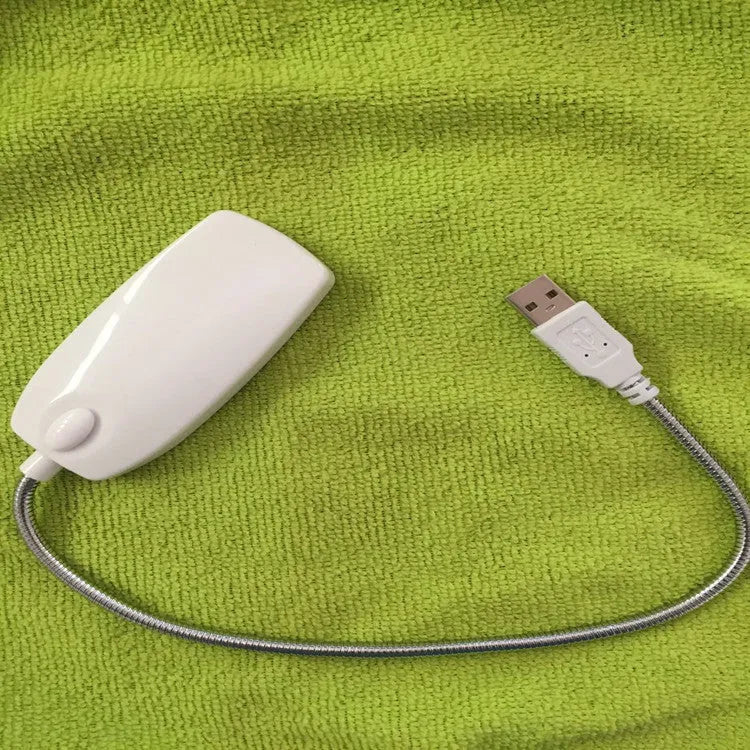 Flexible gooseneck USB LED lamp in multiple colours on a desk next to a laptop