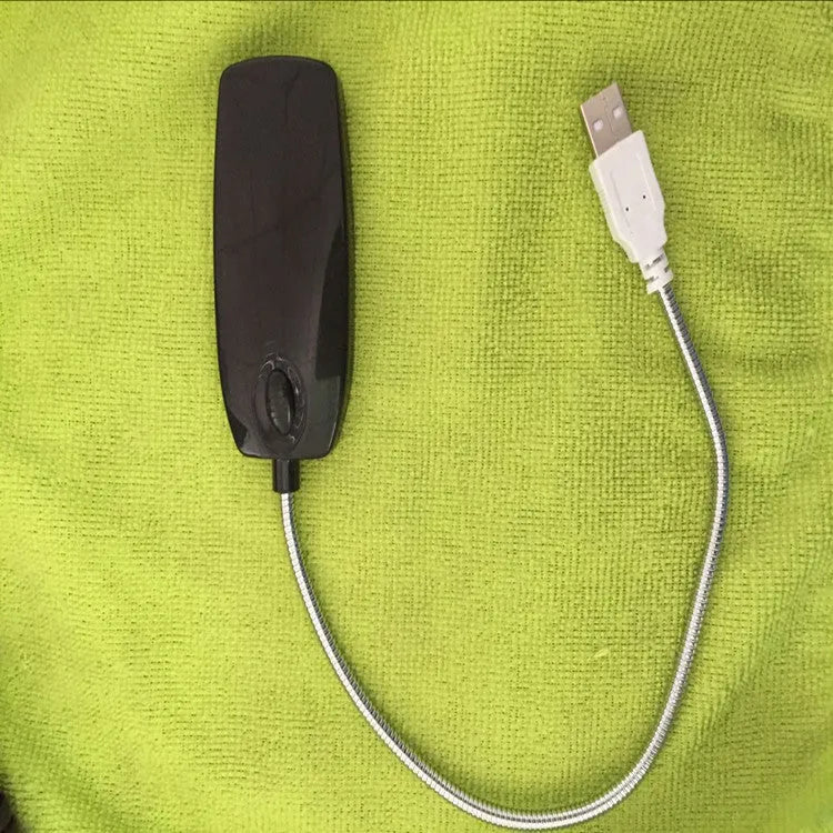 Flexible gooseneck USB LED lamp in multiple colours on a desk next to a laptop