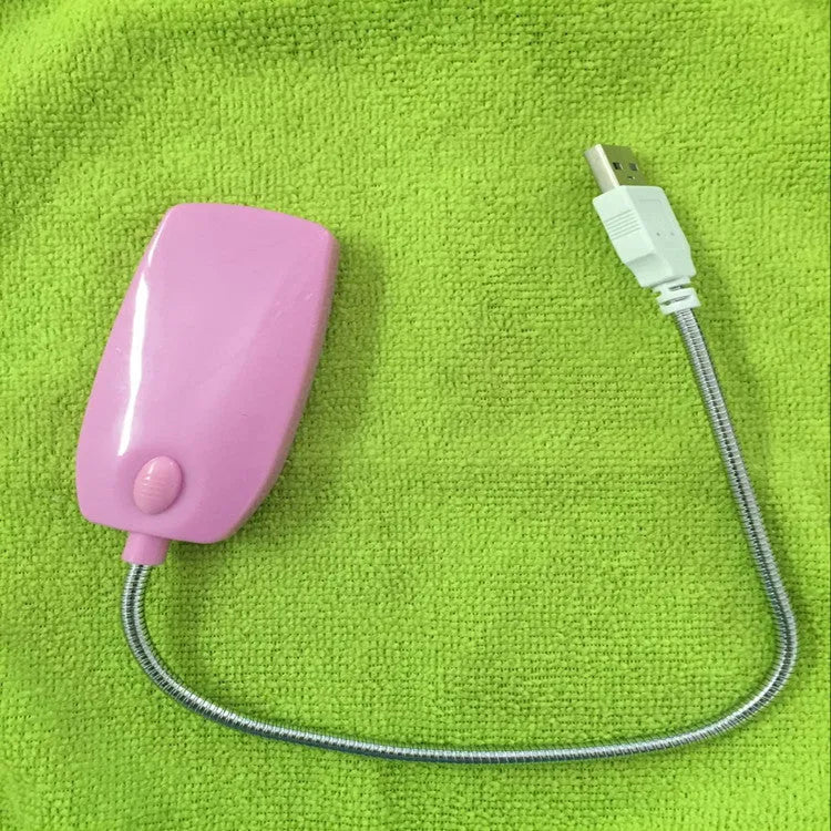 Flexible gooseneck USB LED lamp in multiple colours on a desk next to a laptop
