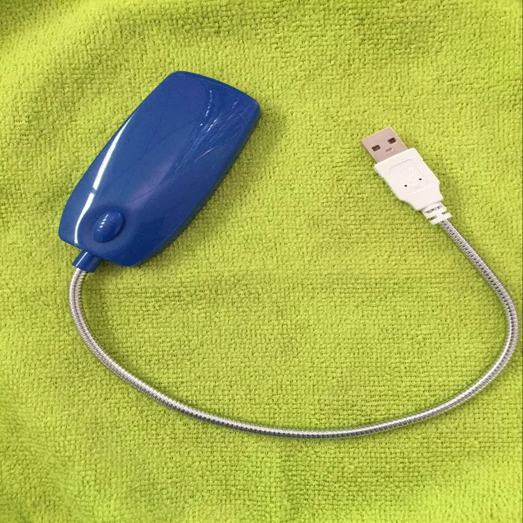 Flexible gooseneck USB LED lamp in multiple colours on a desk next to a laptop