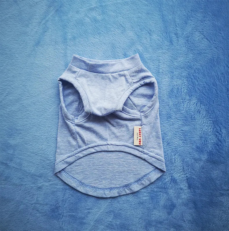 Cotton dog vest in dark blue on a small dog, showing back length and chest fit
