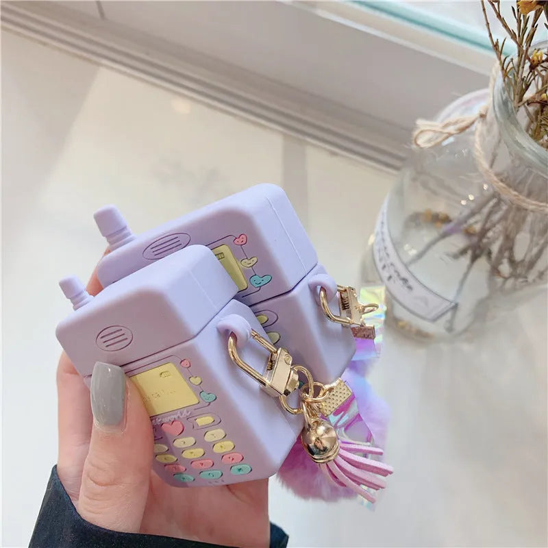 Purple silicone AirPods protective case with fluffy fur ball pendant attached