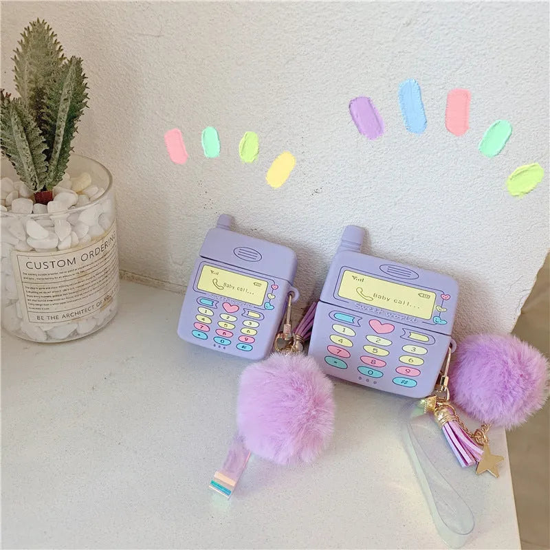 Purple silicone AirPods protective case with fluffy fur ball pendant attached