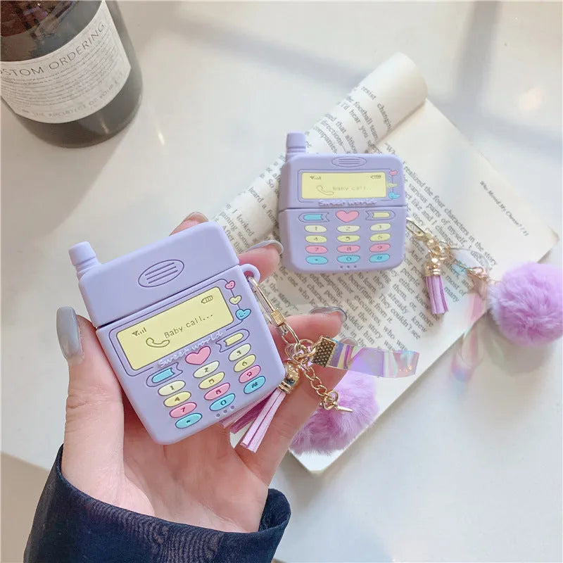 Purple silicone AirPods protective case with fluffy fur ball pendant attached