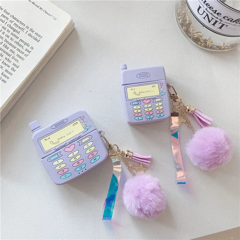 Purple silicone AirPods protective case with fluffy fur ball pendant attached