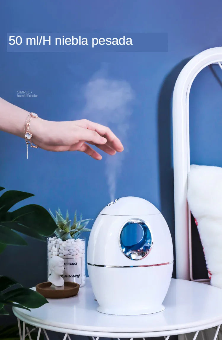 White round aromatherapy humidifier with USB cable and water tank showing mist output