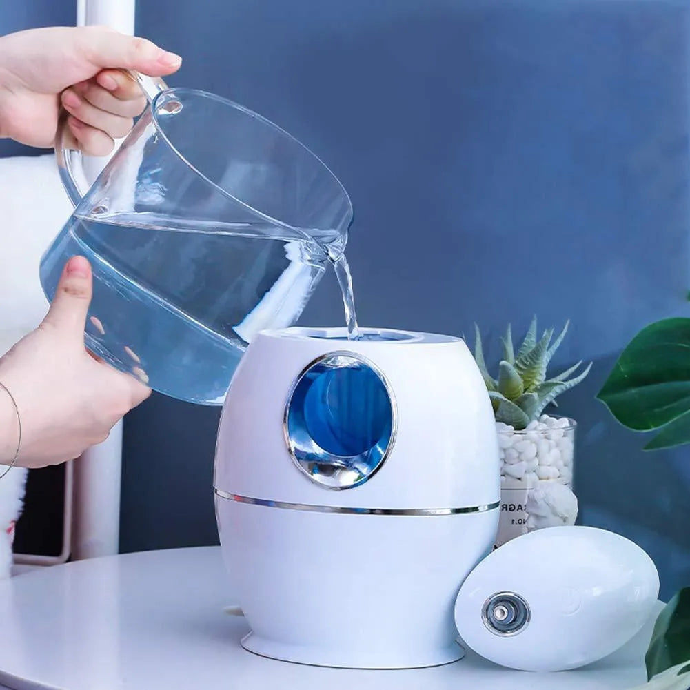 White round aromatherapy humidifier with USB cable and water tank showing mist output