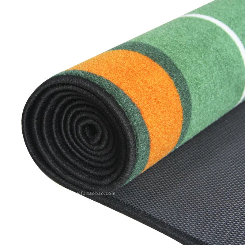 Golf putting practice blanket in green style laid on grass with a putter and ball