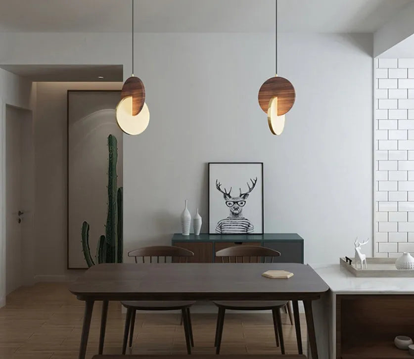 Long-line walnut wood chandelier with carved details and warm lighting