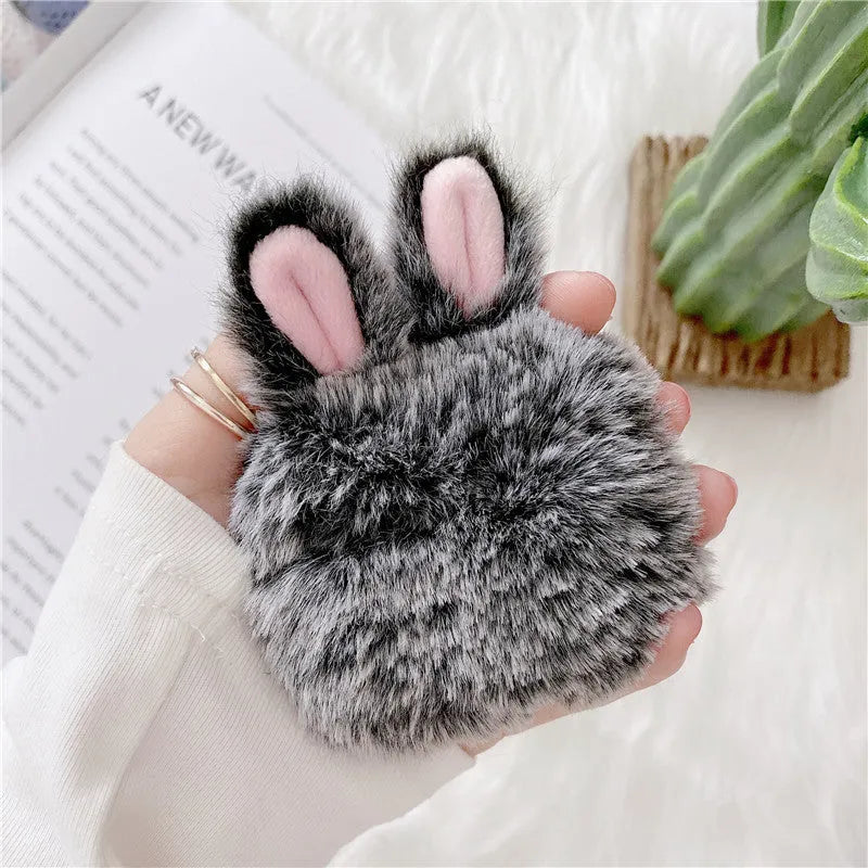 Pink soft silicone AirPods cover with grey plush rabbit ears attached to the top.