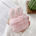 Pink soft silicone AirPods cover with grey plush rabbit ears attached to the top.