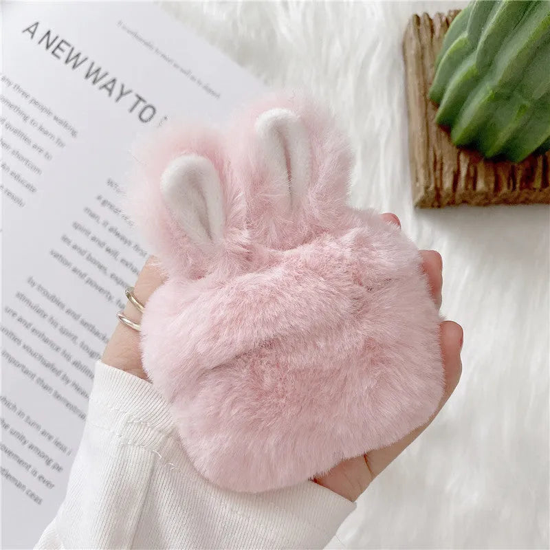 Pink soft silicone AirPods cover with grey plush rabbit ears attached to the top.