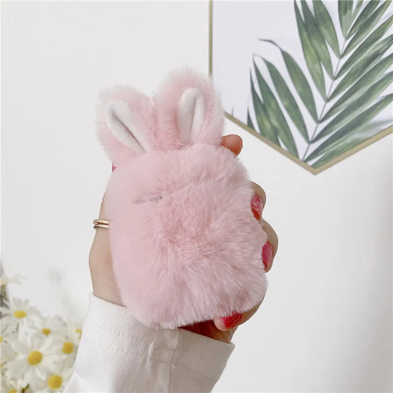 Pink soft silicone AirPods cover with grey plush rabbit ears attached to the top.