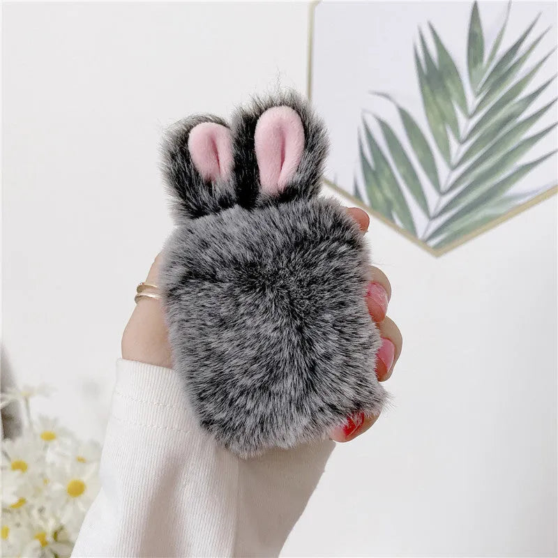 Pink soft silicone AirPods cover with grey plush rabbit ears attached to the top.