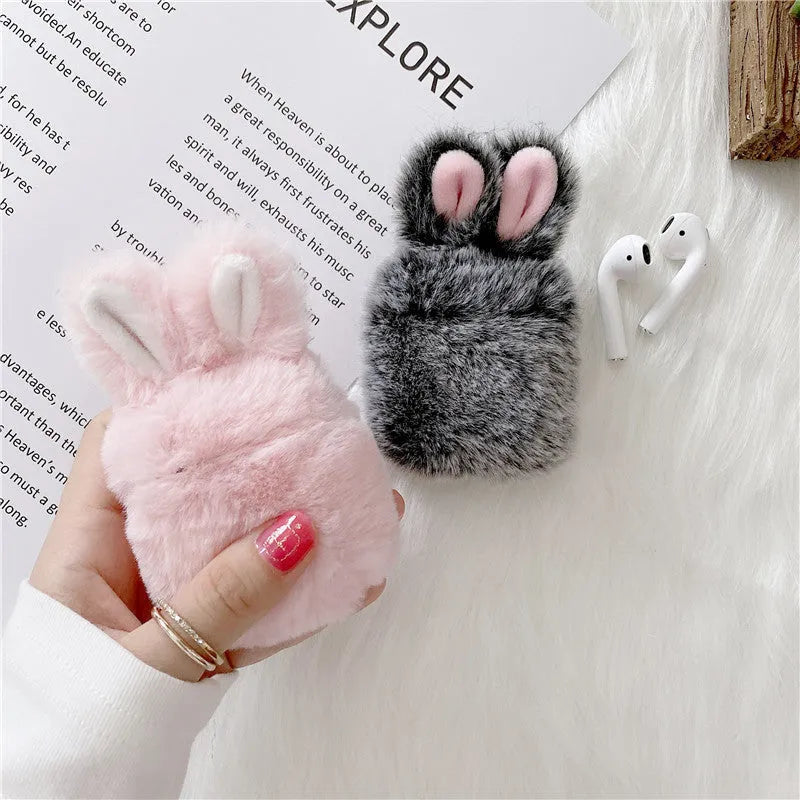 Pink soft silicone AirPods cover with grey plush rabbit ears attached to the top.