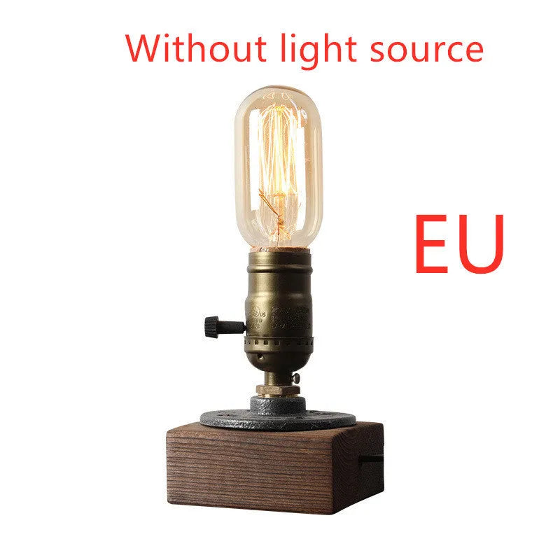 Compact water pipe design table lamp made from wood and iron on a wooden surface.