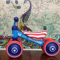 Plastic no-pedal baby balance bike with three wheels, carbon steel frame, EVA foam tyres, and artificial PU leather seat