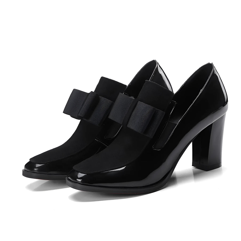 Black patent leather women's high heels with a thick chunky heel and square toe on a rubber sole.
