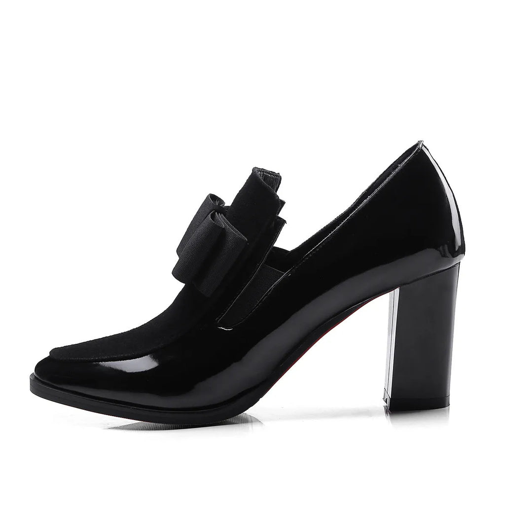 Black patent leather women's high heels with a thick chunky heel and square toe on a rubber sole.