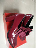 Black patent leather women's high heels with a thick chunky heel and square toe on a rubber sole.