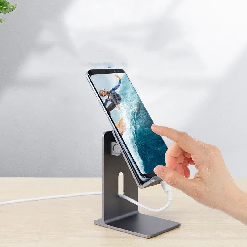 Alloy mobile phone and tablet holder in dark gray on a wooden desk