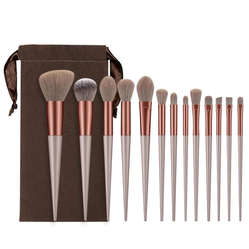 13-piece Wizard of Oz green makeup brush set with man-made fibre bristles and wooden handles in cloth bag