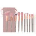 13-piece Wizard of Oz green makeup brush set with man-made fibre bristles and wooden handles in cloth bag