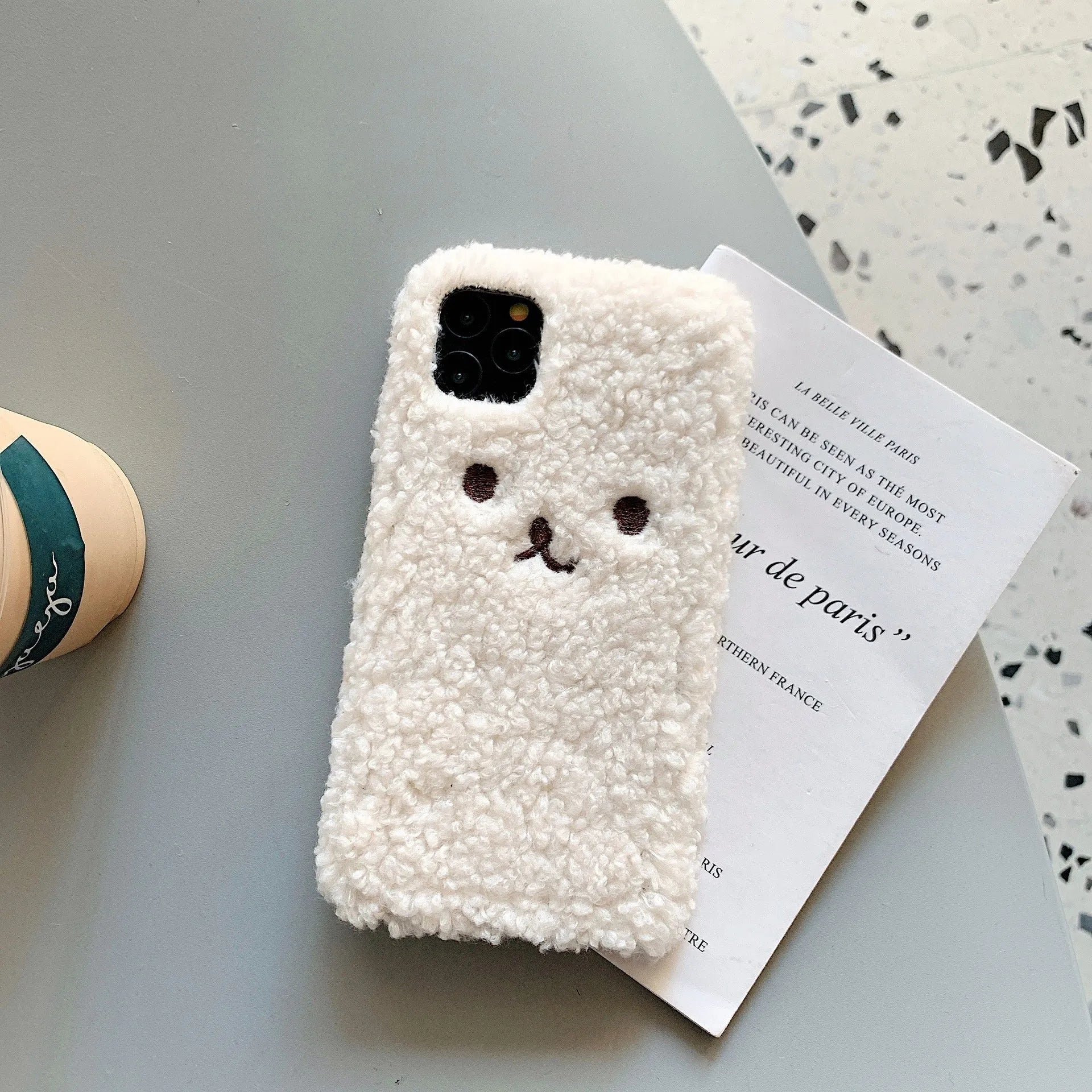 Soft TPU iPhone case with embroidered cartoon bear face in brown and white colour options