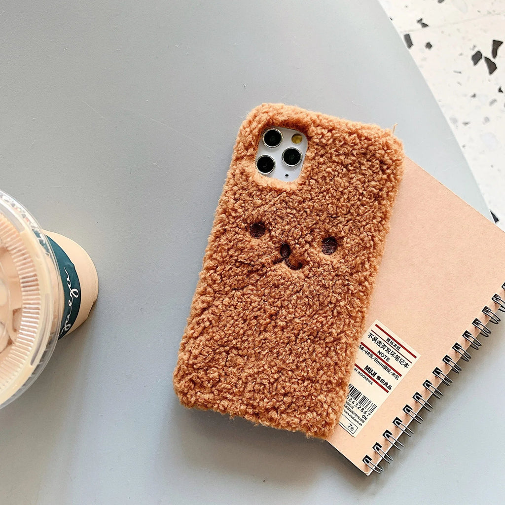 Soft TPU iPhone case with embroidered cartoon bear face in brown and white colour options
