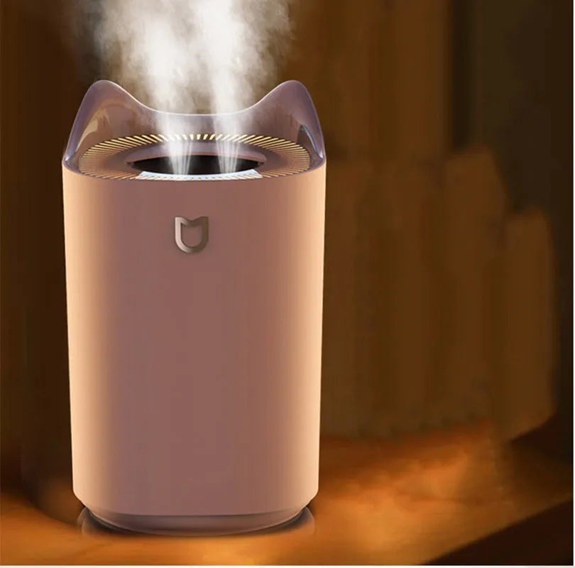 Coral Pink double spray USB humidifier with three mist outlets on a wooden table.
