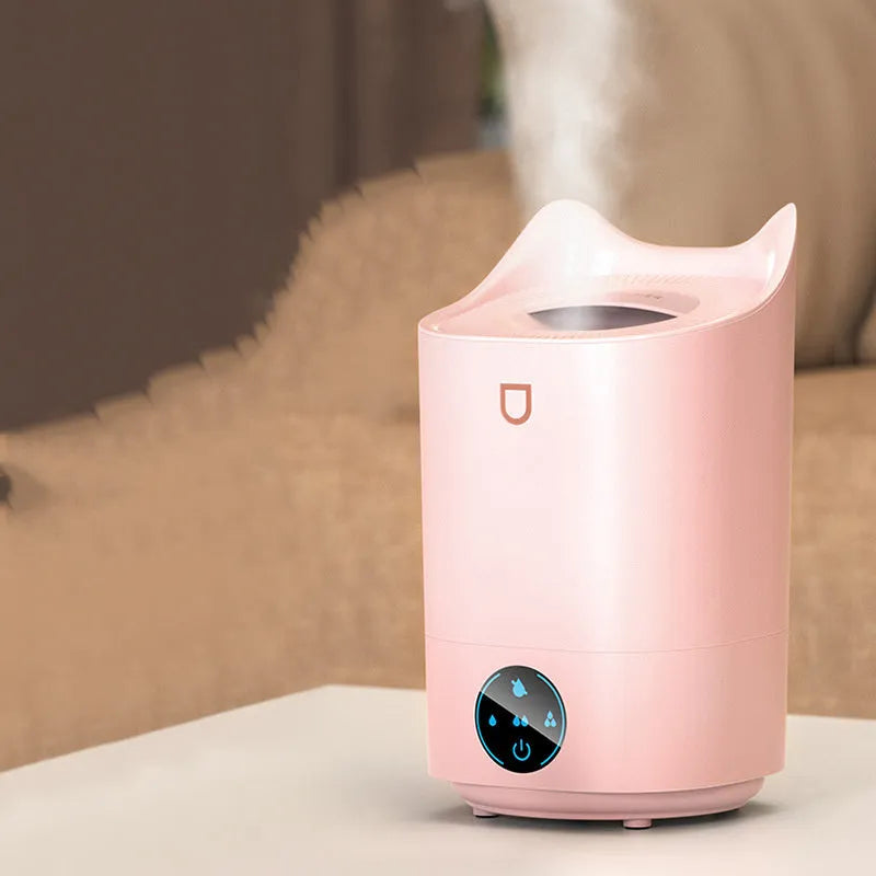 Coral Pink double spray USB humidifier with three mist outlets on a wooden table.
