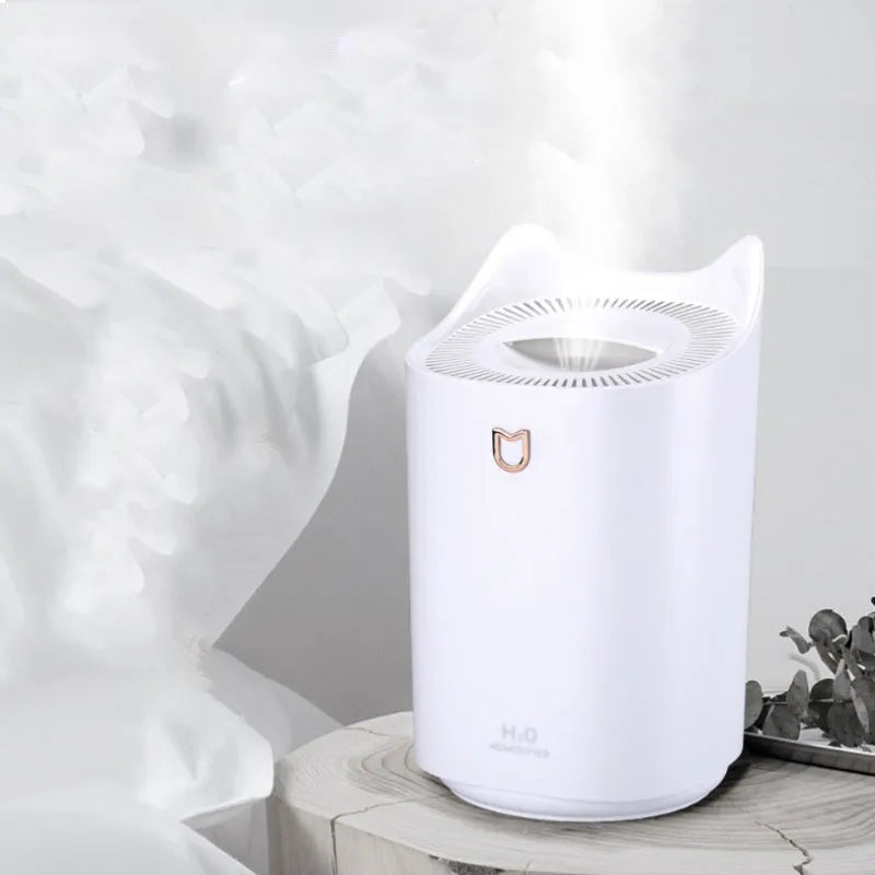 Coral Pink double spray USB humidifier with three mist outlets on a wooden table.