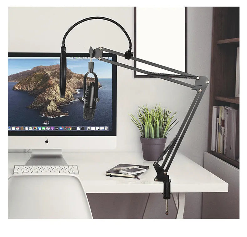 Black USB condenser microphone with foam cover on a metal stand for desktop recording.