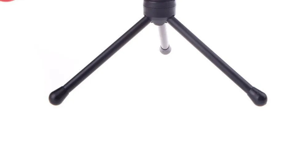 Black wired PC microphone with adjustable metal clip and separate desk mounting bracket on a white background