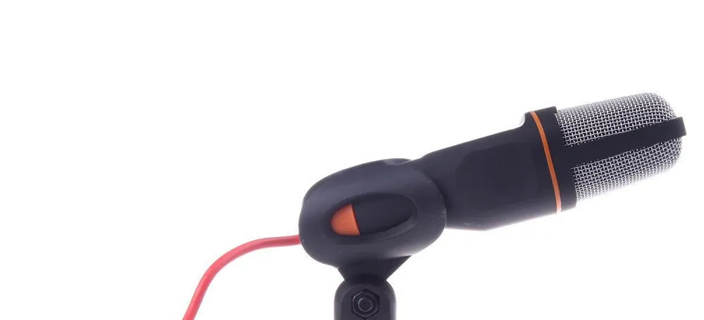 Black wired PC microphone with adjustable metal clip and separate desk mounting bracket on a white background